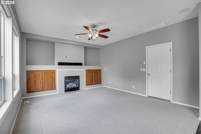 16099 SE Venice Ridge Way, Damascus, OR 97089 - unfurnished living room with ceiling fan, a tiled fireplace, and carpet floors