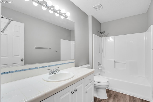 16099 SE Venice Ridge Way, Damascus, OR 97089 - full bath featuring vanity, bathing tub / shower combination, and wood finished floors