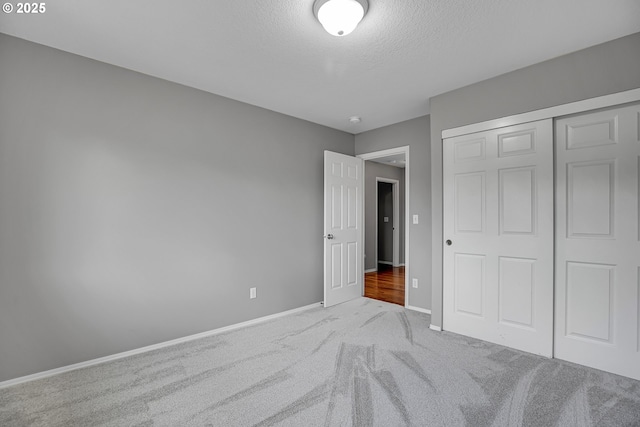 16099 SE Venice Ridge Way, Damascus, OR 97089 - unfurnished bedroom featuring carpet, a textured ceiling, and a closet
