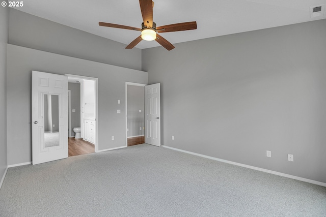 16099 SE Venice Ridge Way, Damascus, OR 97089 - unfurnished bedroom with carpet flooring, lofted ceiling, ensuite bathroom, and a ceiling fan