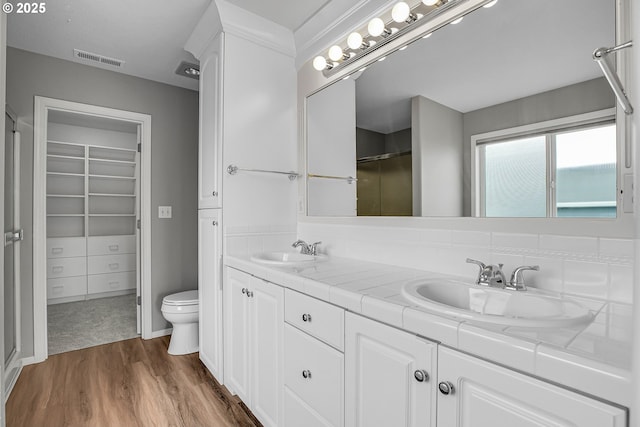 16099 SE Venice Ridge Way, Damascus, OR 97089 - full bathroom with double vanity, wood finished floors, a shower, and a spacious closet