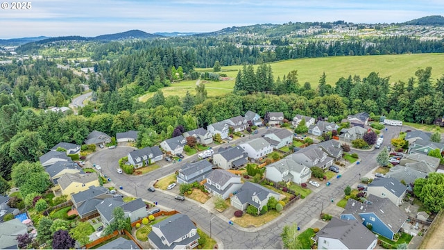 16099 SE Venice Ridge Way, Damascus, OR 97089 - aerial view of residential area featuring a mountainous background and a heavily wooded area