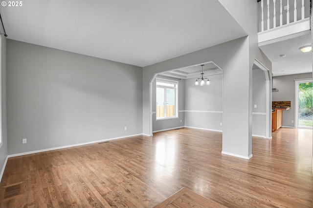 16099 SE Venice Ridge Way, Damascus, OR 97089 - unfurnished living room with wood finished floors and a chandelier