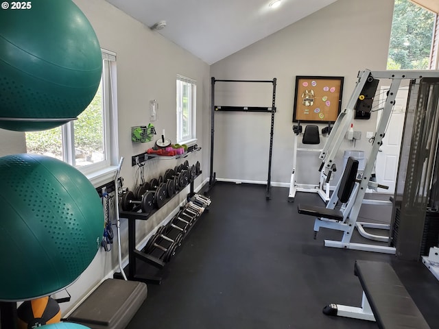 exercise room with baseboards and vaulted ceiling