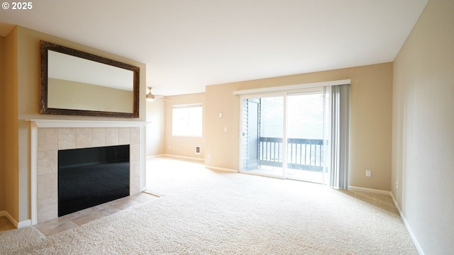 unfurnished living room featuring light carpet, a fireplace, and baseboards