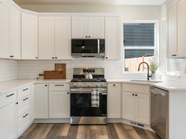 13688 Sandra Loop, Oregon City, OR 97045 - kitchen with stainless steel appliances, a sink, light countertops, and backsplash