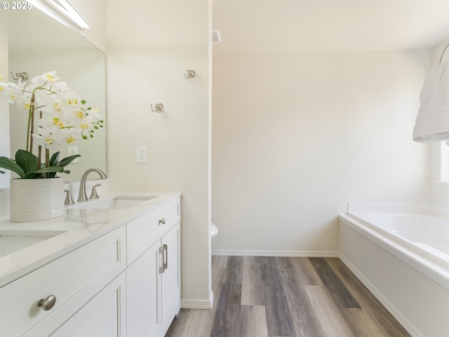 13688 Sandra Loop, Oregon City, OR 97045 - full bath with wood finished floors, double vanity, a garden tub, and baseboards