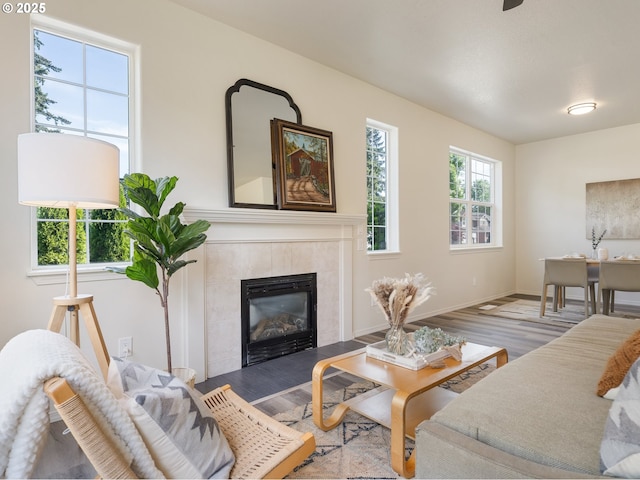 13688 Sandra Loop, Oregon City, OR 97045 - living room featuring wood finished floors, a tiled fireplace, and baseboards