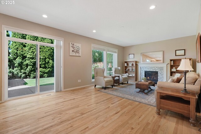 2475 NE 10th Ave, Hillsboro, OR 97124 - living area featuring light wood-style floors, baseboards, recessed lighting, and a fireplace