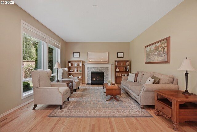 2475 NE 10th Ave, Hillsboro, OR 97124 - living room with light wood-type flooring, healthy amount of natural light, baseboards, and a tile fireplace