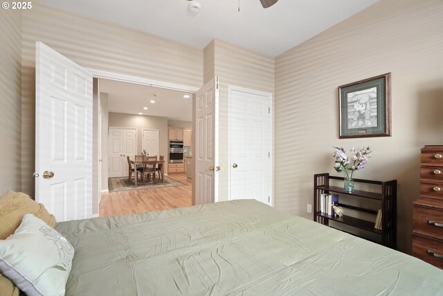 2475 NE 10th Ave, Hillsboro, OR 97124 - bedroom with light wood finished floors, wallpapered walls, recessed lighting, and a ceiling fan