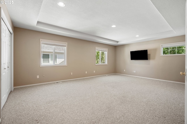 2475 NE 10th Ave, Hillsboro, OR 97124 - unfurnished room with a tray ceiling, light colored carpet, plenty of natural light, a textured ceiling, and recessed lighting