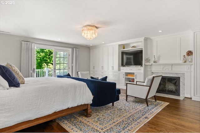 2505 SW Hillcrest Dr, Portland, OR 97201 - bedroom featuring access to exterior, dark wood-type flooring, a premium fireplace, a chandelier, and recessed lighting