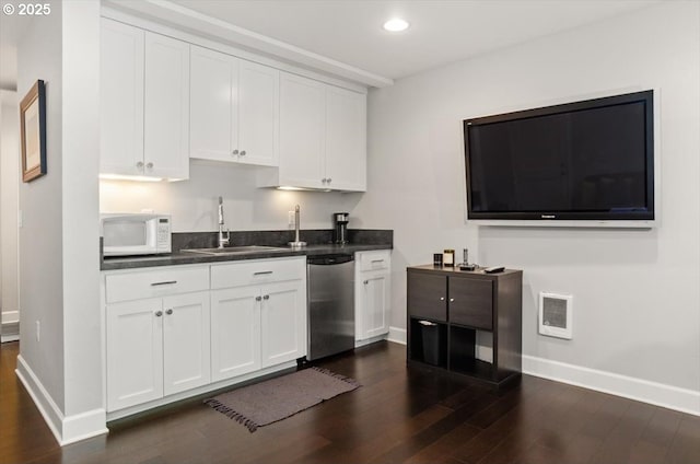 2505 SW Hillcrest Dr, Portland, OR 97201 - kitchen featuring stainless steel dishwasher, a sink, white microwave, dark wood-style floors, and recessed lighting