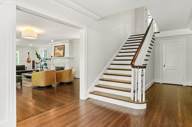 2505 SW Hillcrest Dr, Portland, OR 97201 - stairs featuring wood finished floors, a fireplace, ornamental molding, and baseboards