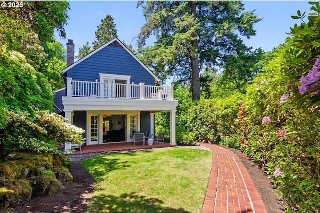 2505 SW Hillcrest Dr, Portland, OR 97201 - rear view of house with a balcony, a yard, and a chimney