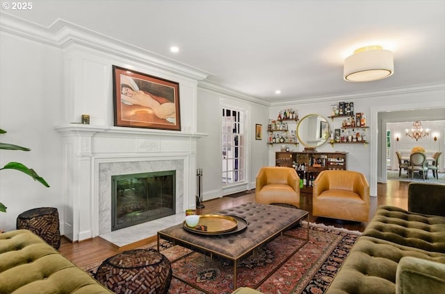 2505 SW Hillcrest Dr, Portland, OR 97201 - living area featuring ornamental molding, wood finished floors, a chandelier, a fireplace, and baseboards