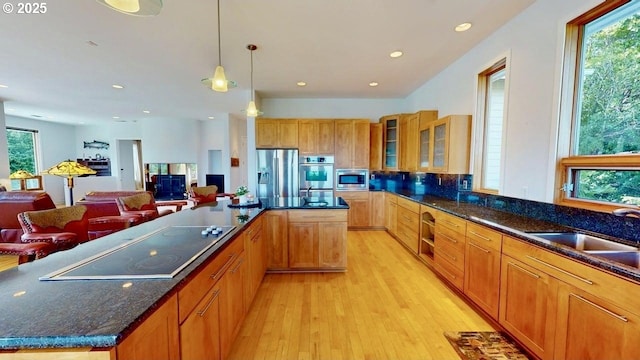 94414 Tom Cat Hill Rd, Gold Beach, OR 97444 - kitchen featuring stainless steel appliances, light wood-style flooring, a kitchen island, open floor plan, and glass insert cabinets