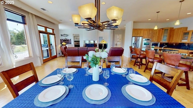 94414 Tom Cat Hill Rd, Gold Beach, OR 97444 - dining area featuring light wood finished floors, a chandelier, and recessed lighting
