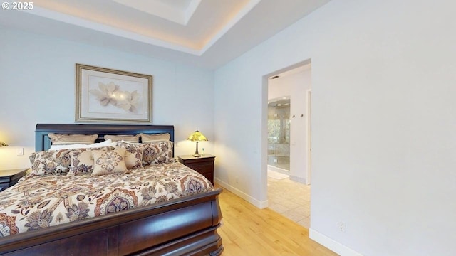 94414 Tom Cat Hill Rd, Gold Beach, OR 97444 - bedroom with light wood-type flooring and a raised ceiling