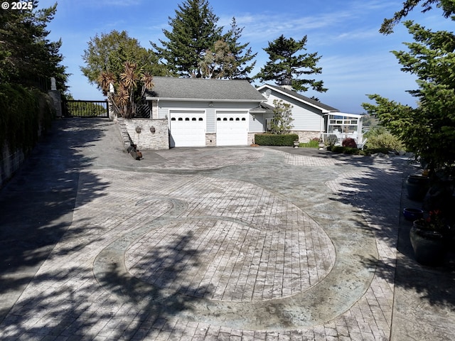 94414 Tom Cat Hill Rd, Gold Beach, OR 97444 - view of property exterior featuring a garage, stone siding, and decorative driveway