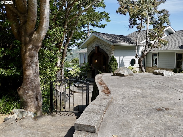 94414 Tom Cat Hill Rd, Gold Beach, OR 97444 - view of front of home with a gate and stone siding