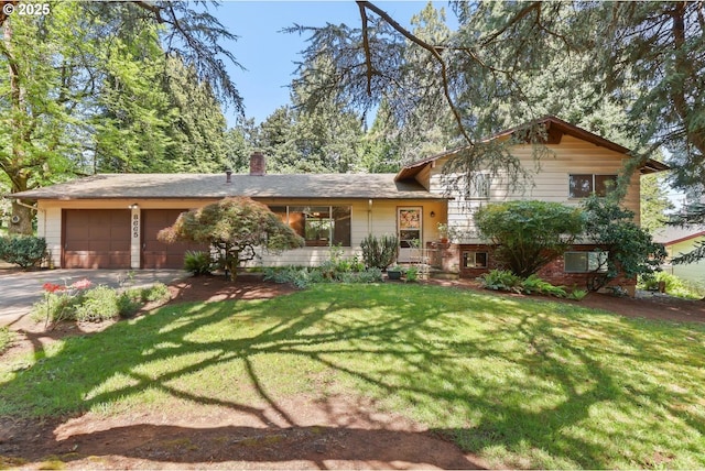 tri-level home with a garage, a chimney, driveway, and a front yard