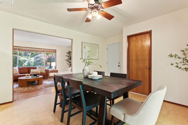 dining space with baseboards and ceiling fan