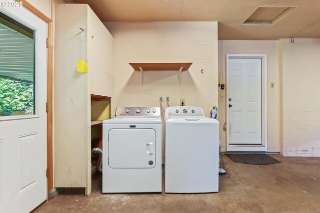 clothes washing area with laundry area, attic access, and washing machine and clothes dryer