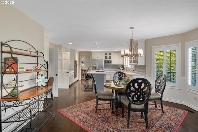 dining room with a chandelier, dark wood-style floors, recessed lighting, and baseboards