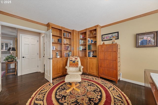 sitting room with dark wood-style floors, baseboards, and crown molding