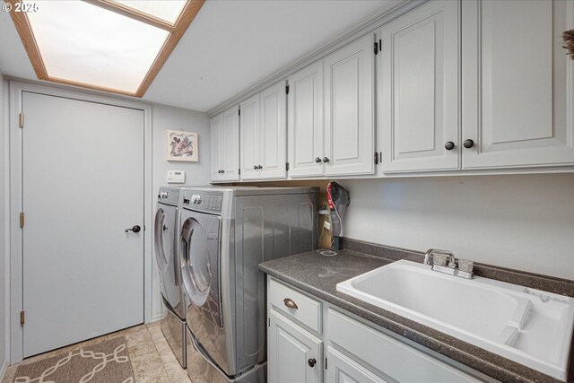 laundry area with independent washer and dryer and cabinet space