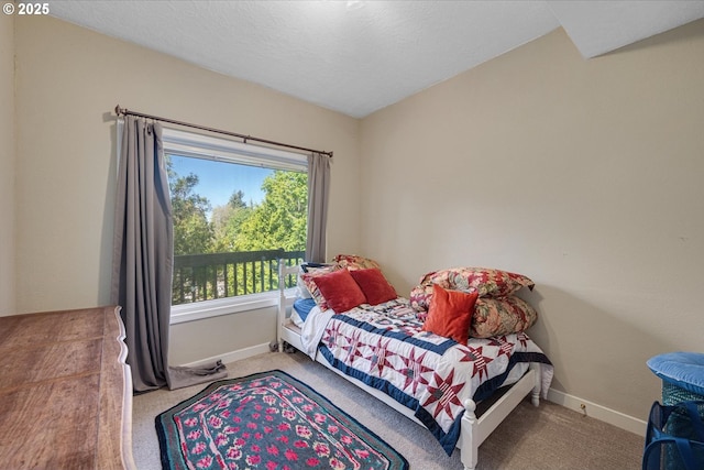 bedroom featuring carpet and baseboards