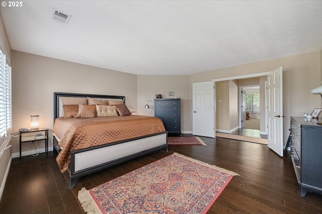 bedroom with hardwood / wood-style floors and baseboards