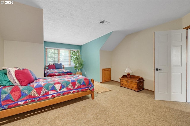 carpeted bedroom featuring a textured ceiling