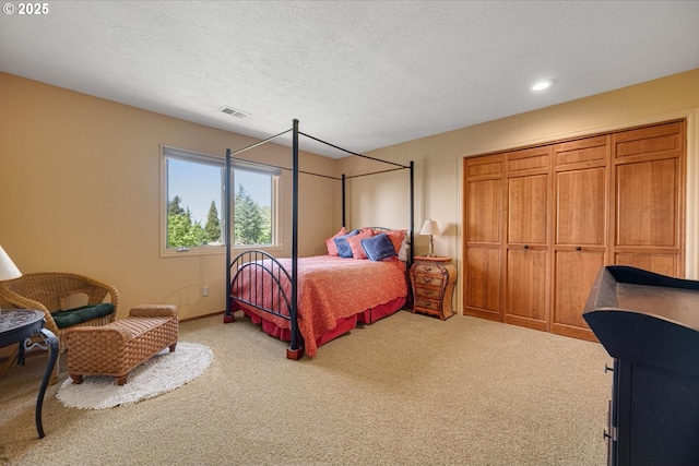 carpeted bedroom with recessed lighting, a textured ceiling, and baseboards