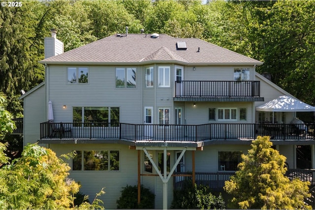 18280 Delenka Ln, Lake Oswego, OR 97034 - back of house featuring a balcony, a chimney, and roof with shingles