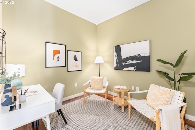 office space with baseboards and wood finished floors