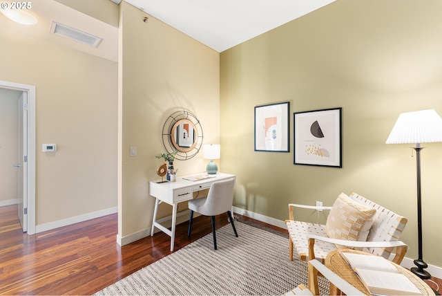 office with baseboards, visible vents, and wood finished floors