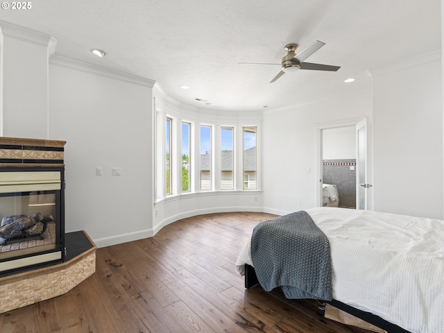 9540 SE Spyglass Dr, Happy Valley, OR 97086 - bedroom featuring crown molding, wood-type flooring, a multi sided fireplace, recessed lighting, and baseboards