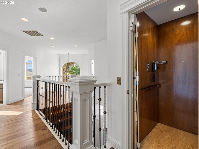 9540 SE Spyglass Dr, Happy Valley, OR 97086 - corridor featuring visible vents, light wood-style floors, baseboards, recessed lighting, and an upstairs landing