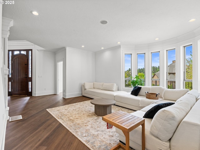 9540 SE Spyglass Dr, Happy Valley, OR 97086 - living room featuring recessed lighting, baseboards, dark wood-type flooring, visible vents, and ornamental molding