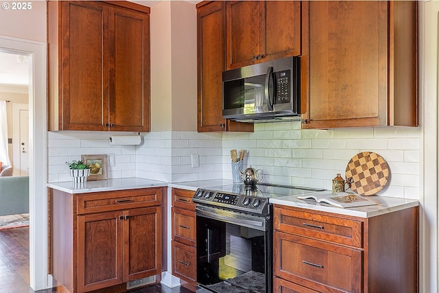 4915 NE 8th Ave, Portland, OR 97211 - kitchen featuring stainless steel microwave, black electric range oven, light countertops, and tasteful backsplash