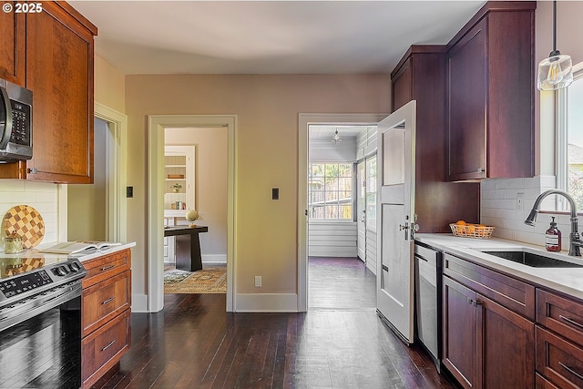 4915 NE 8th Ave, Portland, OR 97211 - kitchen with range with electric cooktop, light countertops, stainless steel microwave, and dark wood finished floors