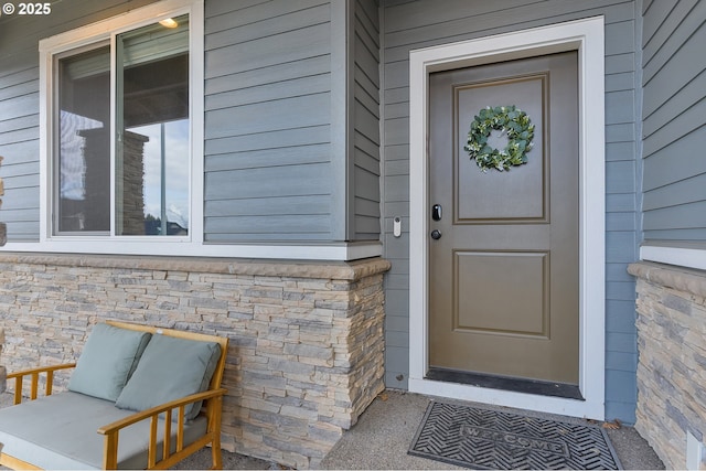 doorway to property featuring stone siding