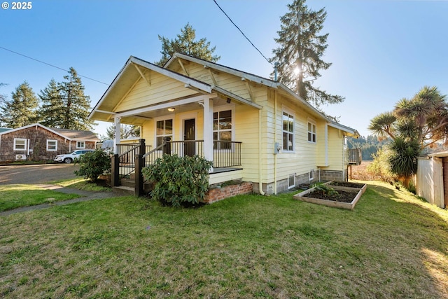 bungalow-style home featuring covered porch and a front lawn