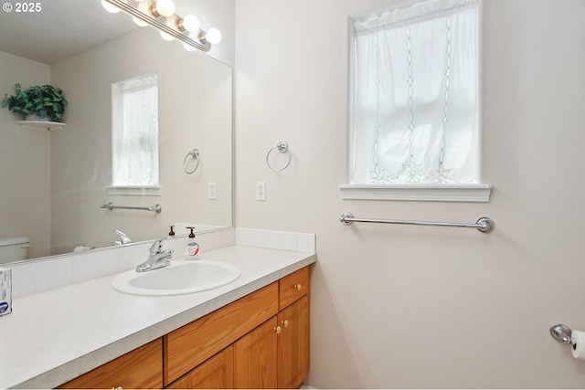 bathroom with toilet and vanity