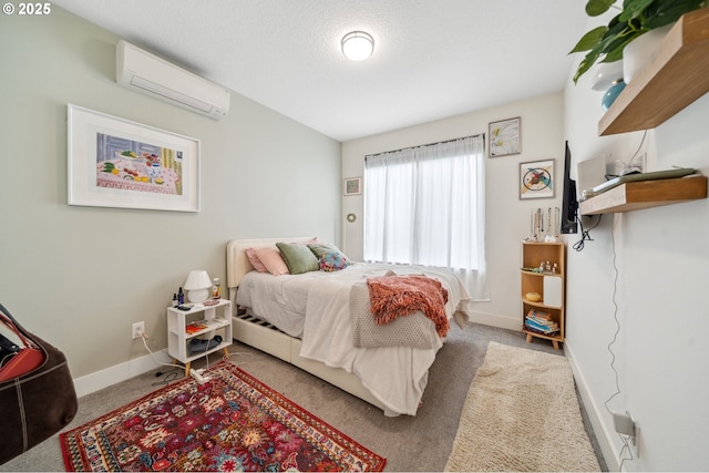 bedroom featuring baseboards, carpet flooring, and a wall mounted AC