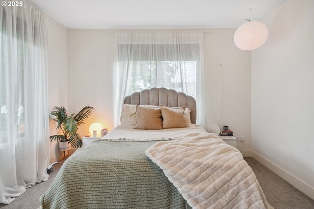 bedroom featuring carpet floors and baseboards
