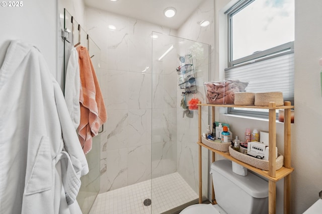 full bathroom with toilet and a marble finish shower